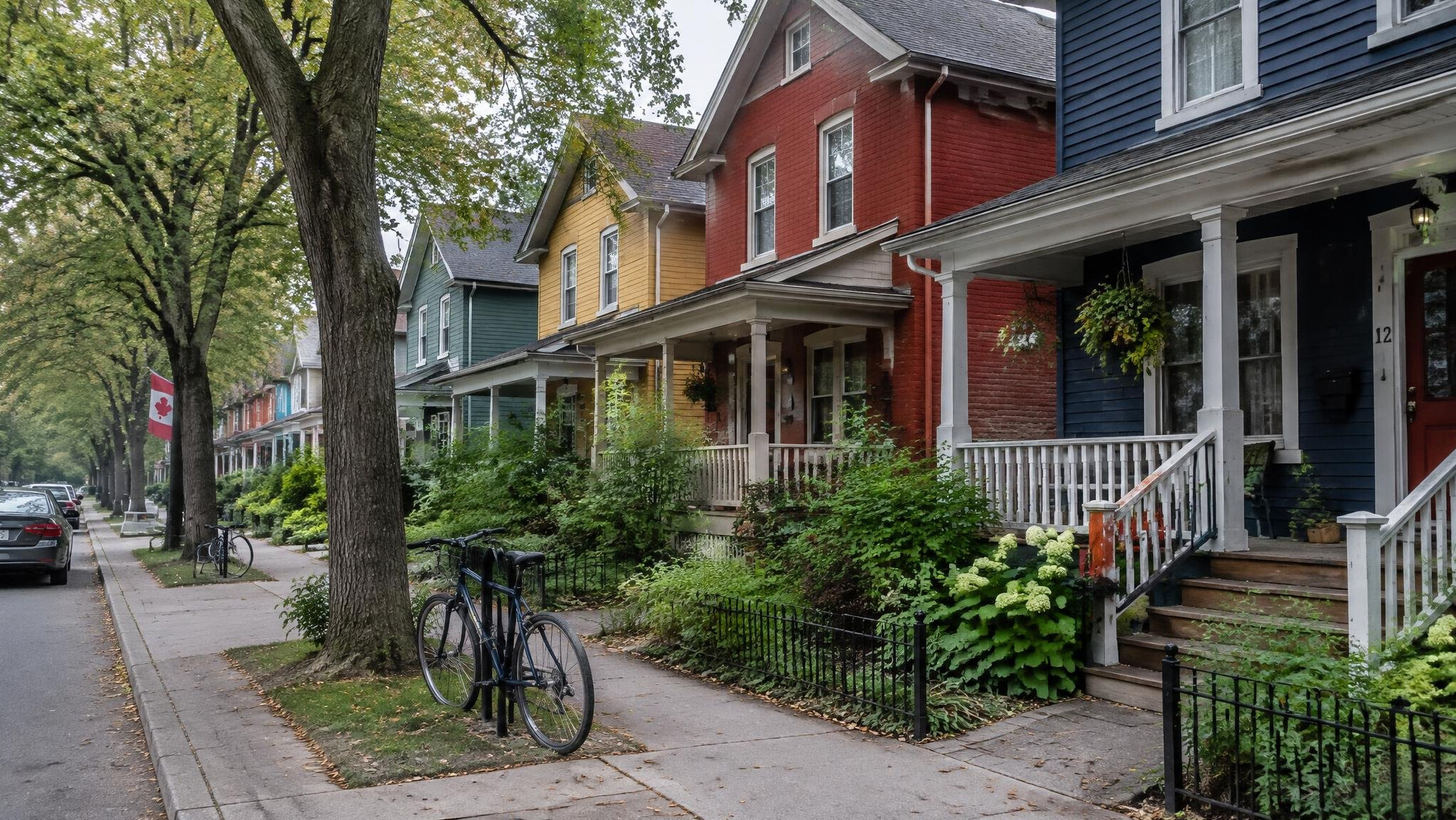 Row of colourful houses with porches on a quiet residential Canadian street