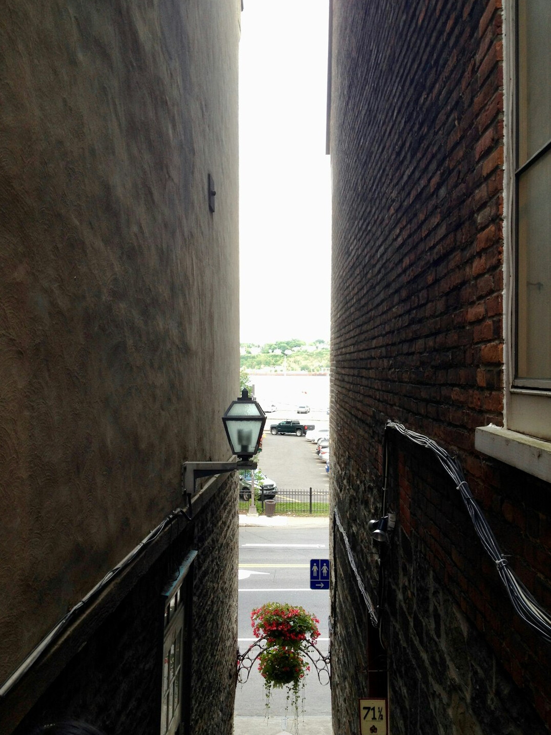 Cobblestone street lined with historic stone buildings in Old Quebec City